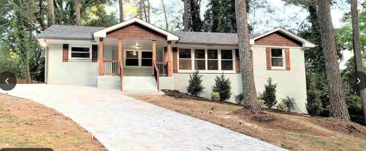 MANAV Capital STR/MTR managed home at Ashwood Dr SE, Smyrna, GA — renovated ranch with cedar shake gables and covered porch.