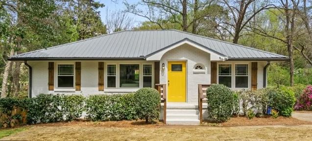 MANAV Capital single-family renovation at Columbia Dr, Decatur, GA — completed craftsman-style ranch home with yellow front door.