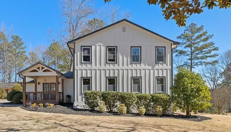 MANAV Capital flagship single-family renovation at Greystone Trce, Marietta, GA — two-story board and batten home.